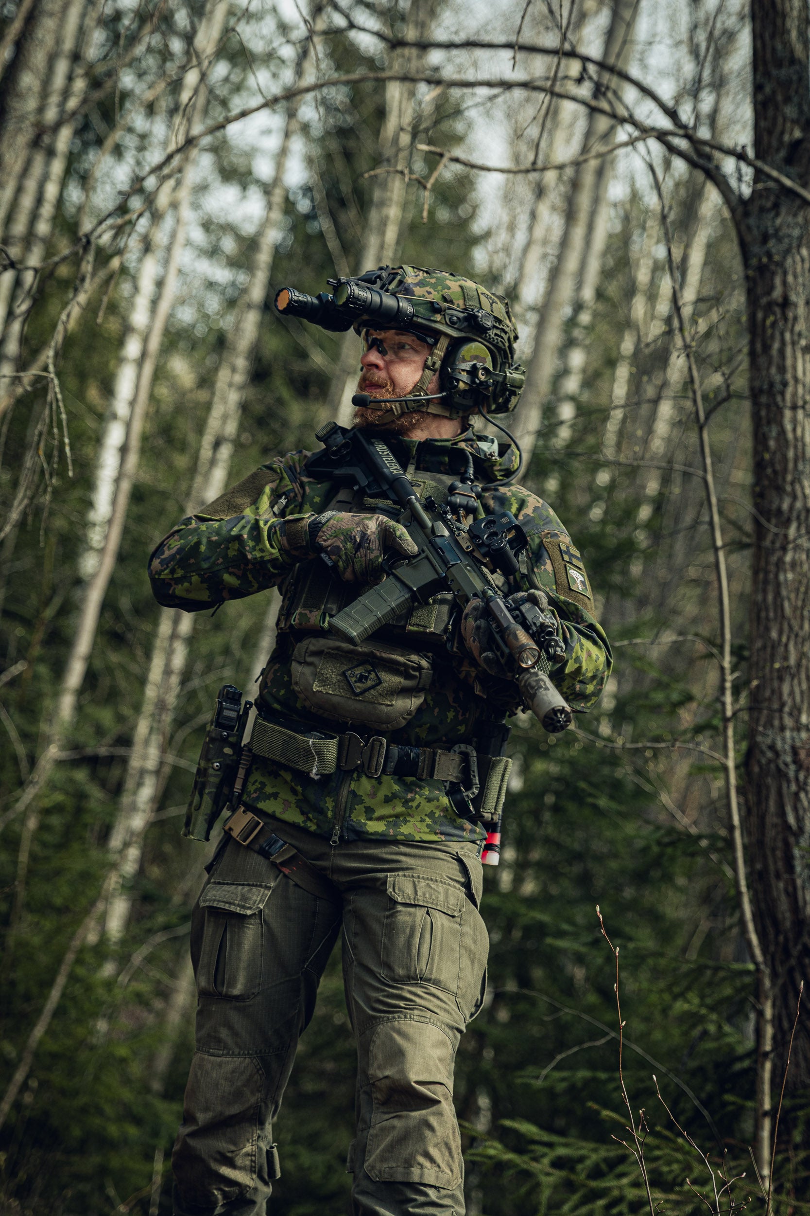 Person in camouflage military gear walking in a forest