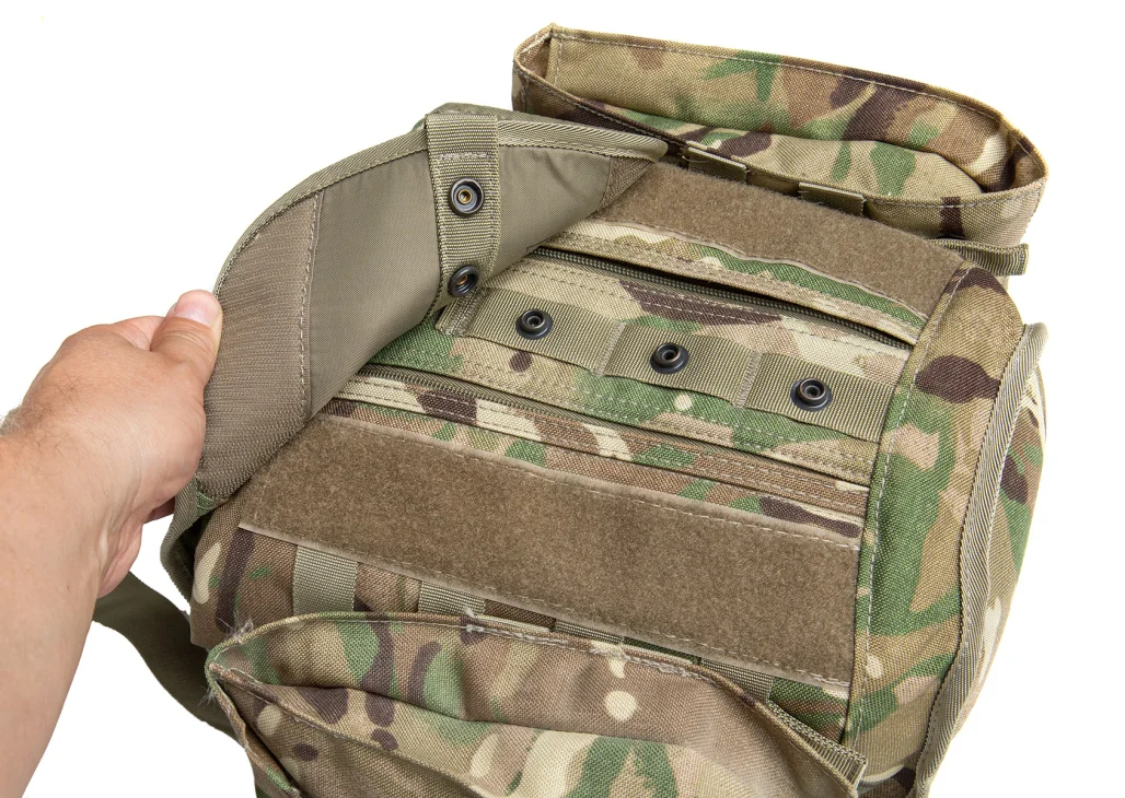 The main compartment is covered by a flap with a hook and loop and snap fastener closure.