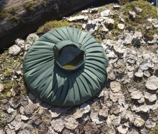 Pleated shaping to keep the bag upright when full of water and set down on the ground.