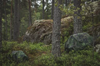 Vasemmalla vanhan mallin 20L suojus CP10 Mini-Taistelurepun päällä, oikealla vanhan mallin 120L suojus RP80 rinkan päällä.