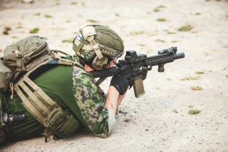 Properly used gloves on a Finnish Brutality 2-gun match participant.