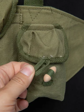 The pockets are closed with wooden toggles.