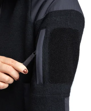 A zippered pocket and a hook & loop slot for patches on one sleeve.