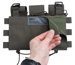 On the backside, there is a hook-and-loop fastener, so you can slap the placard on the plate carrier and it stays there until you rip it off. 