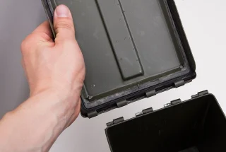 The lid can be removed by opening it and shoving it sideways off the hinge pins.