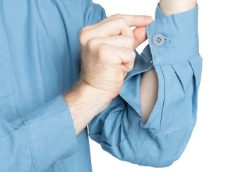 The cuff is closed by a single button as long as you haven't been drinking too much bad vodka beforehand.